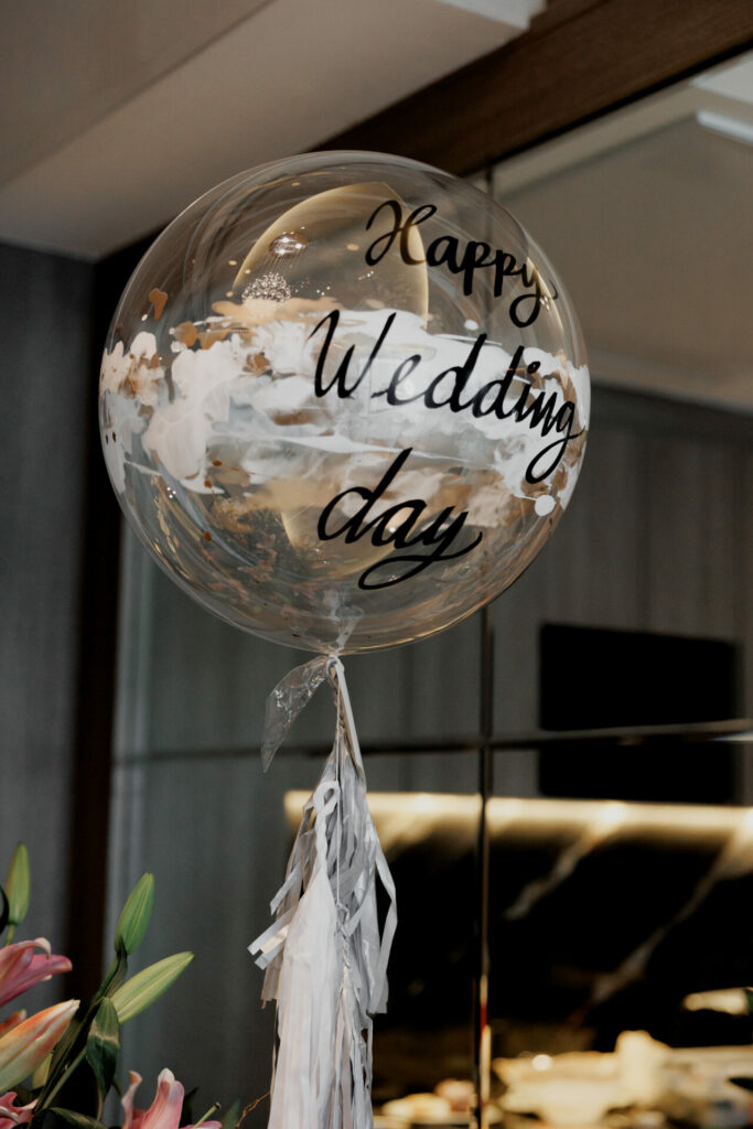 Elegant "Happy Wedding Day" balloon with tassels indoors.