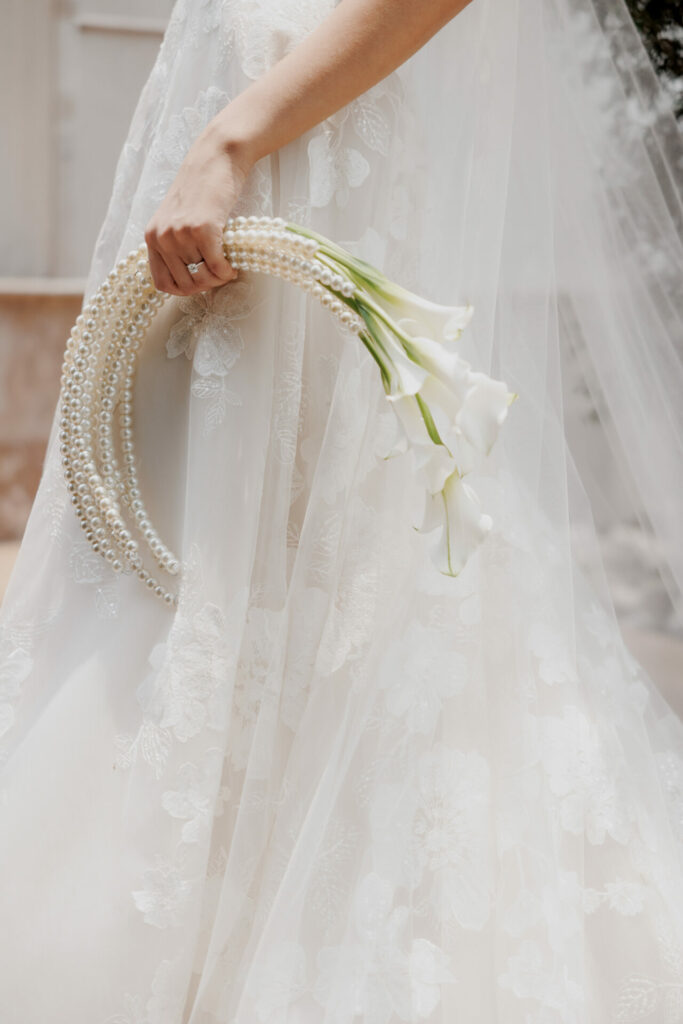 Bride in Mira Zwillinger gown with calla lily bouquet.