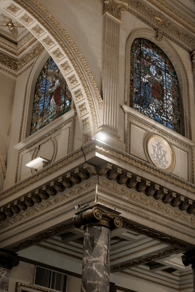 Katya Ruiz in luxury bridal gown amid ornate church.