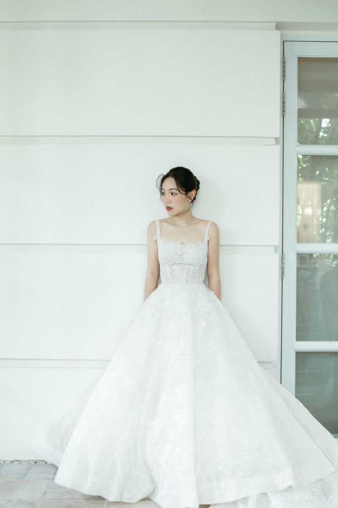 Elegant woman in white bridal couture dress.