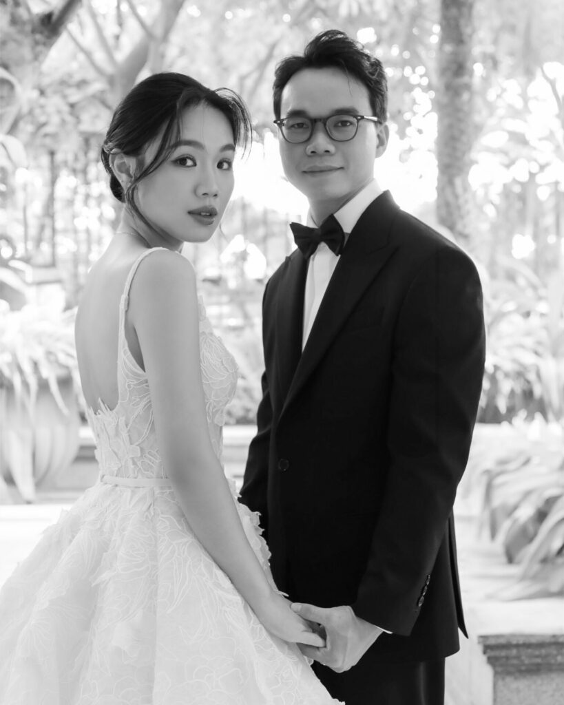 Bride Katya Ruiz in couture gown, holding groom outdoors.
