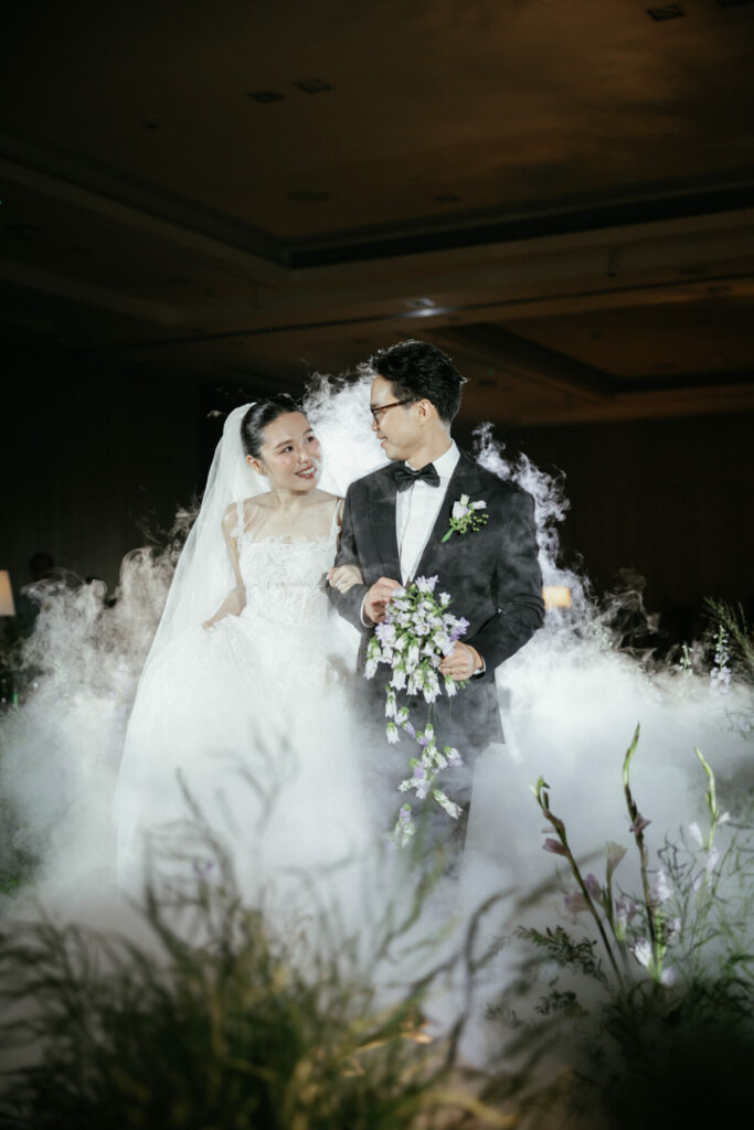 Bride Katya Ruiz and groom smile in white fog.