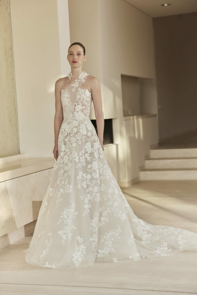 Woman in lace wedding dress, sheer neckline, veil.