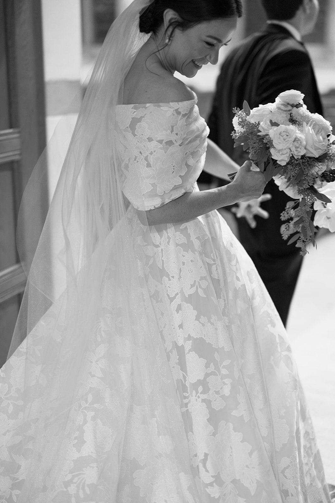 Smiling bride and groom in black and white.