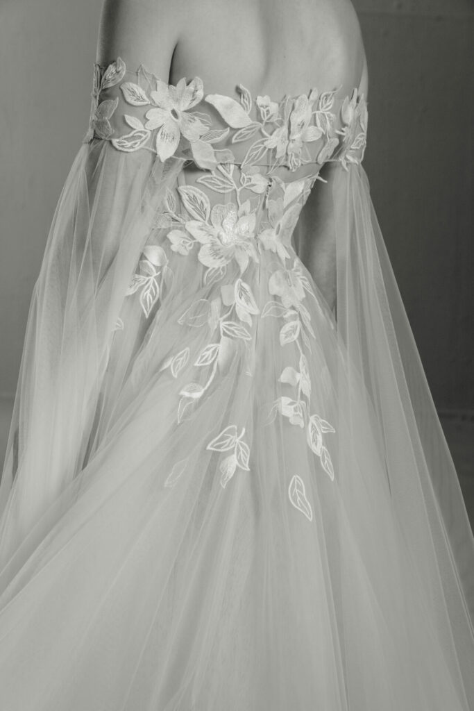 Back view: embroidered off-shoulder wedding dress, black-and-white.