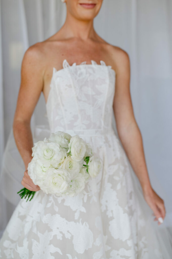 Bride in Mira Zwillinger Amy gown with bouquet.