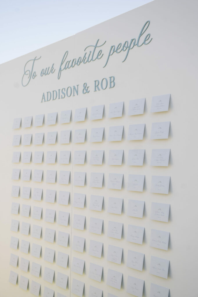 White display wall with envelopes for bridal seating.