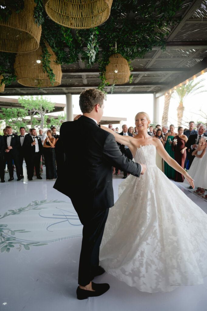 Bride in Mira Zwillinger gown dancing with partner.