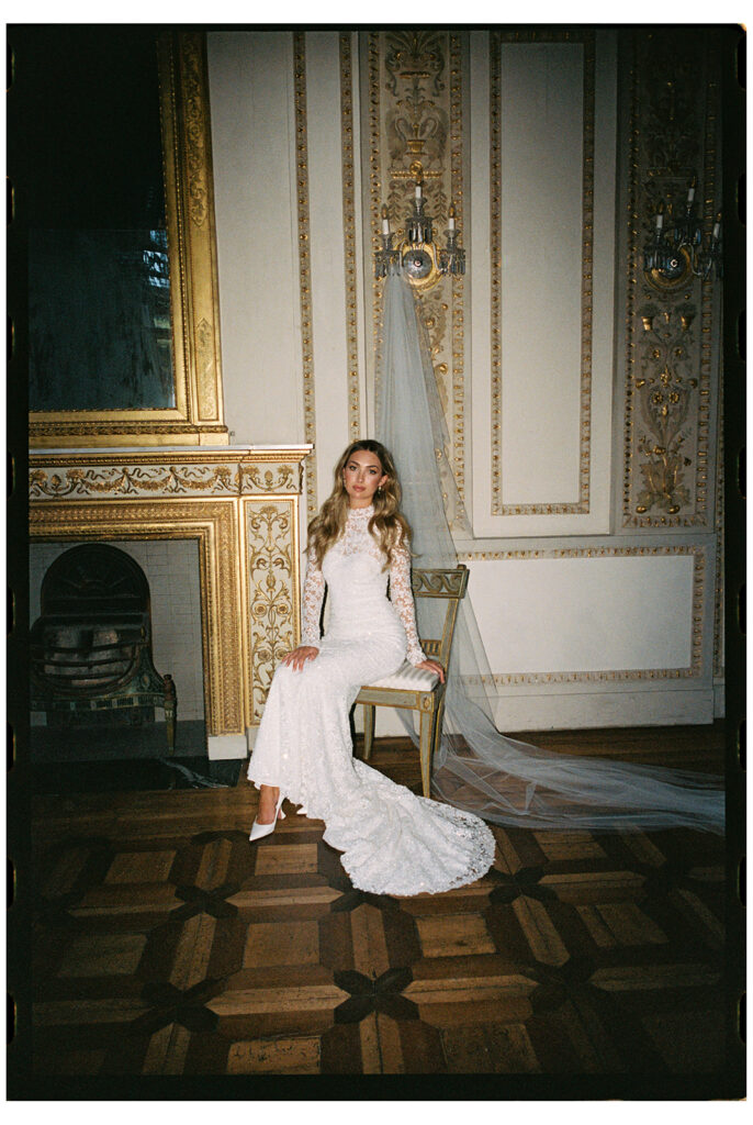 Bride Katya Ruiz in lace gown, ornate room.