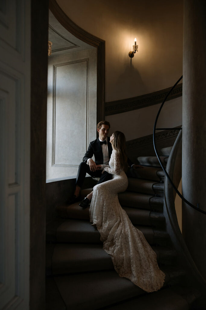 Katya Ruiz and groom share a moment on staircase.