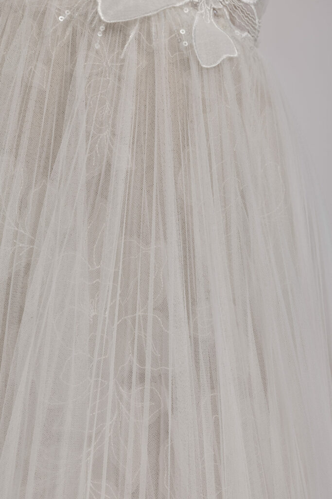 White sheer tulle with floral embroidery and lace.