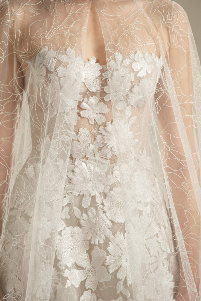 Sheer white wedding gown with embroidered floral lace.
