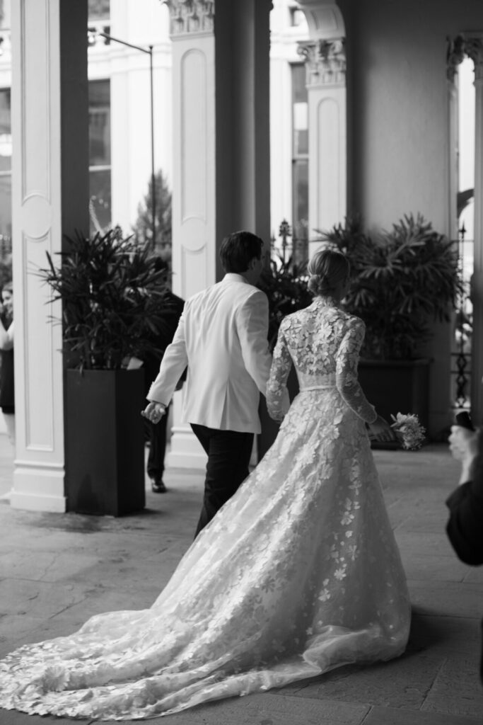 Bride Katya Ruiz in gown, hand-in-hand with groom.