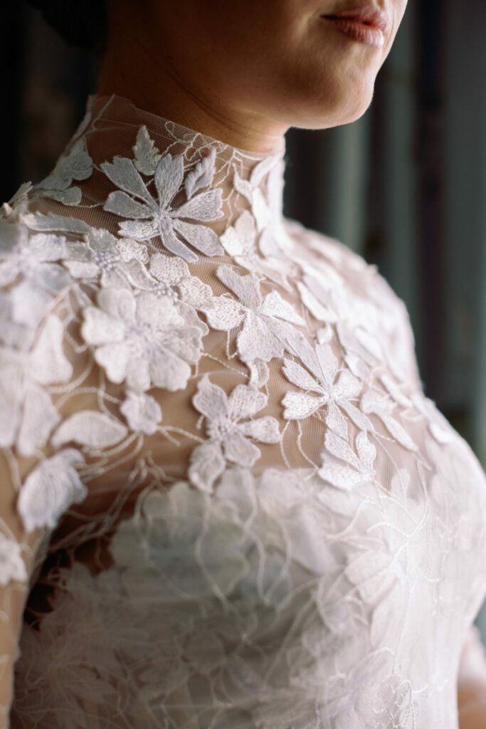 Katya Ruiz in sheer floral Mira Zwillinger gown, glowing softly.