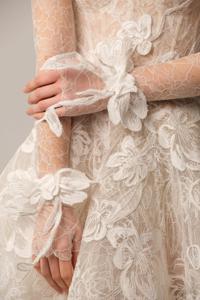 Sheer 3D floral lace dress, bows at wrists.