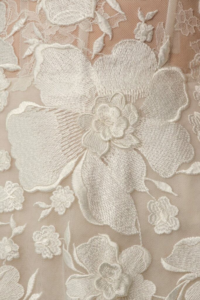 White floral embroidery on sheer beige fabric, SS2026.