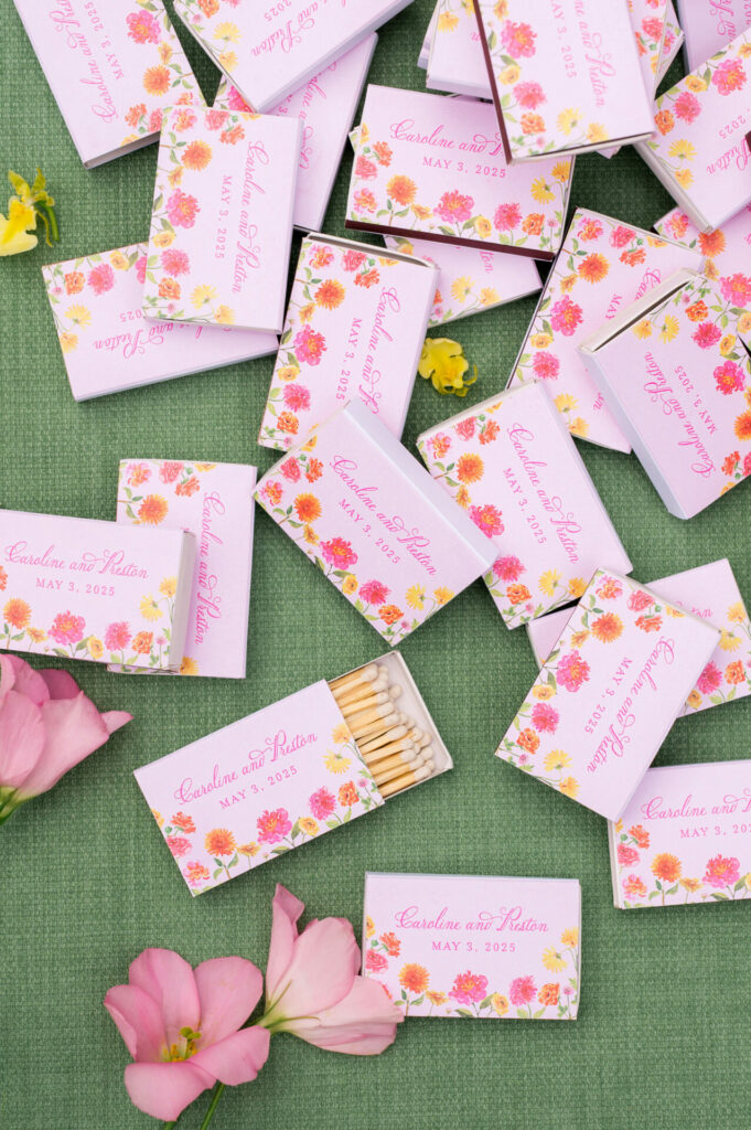 Pastel matchboxes with floral decor, petals, wedding script.
