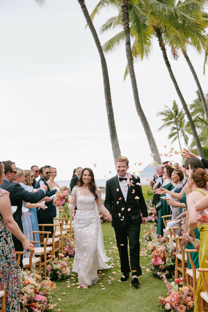 Taylor walks the aisle in her Ness couture gown by Mira Zwillinger with petals flying