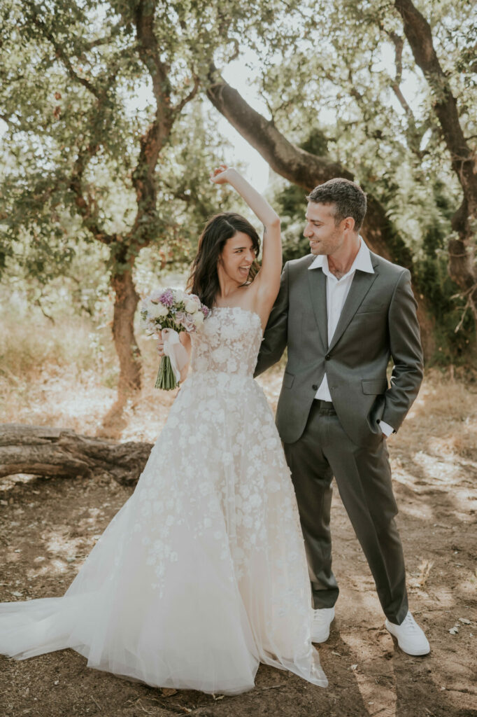 Bride Katya Ruiz dances joyfully outdoors with groom.