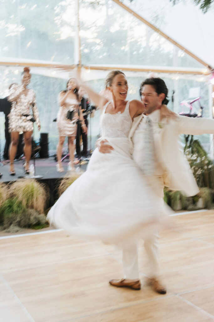 Bride and groom dance as band plays lively music.