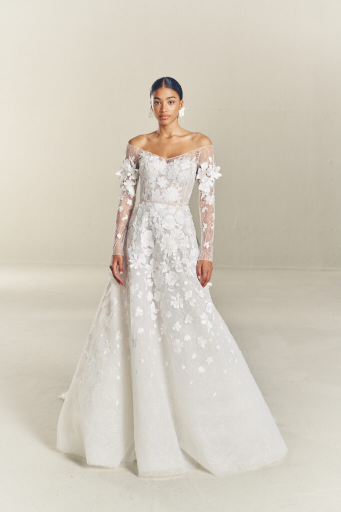 Woman in floral lace off-shoulder wedding gown.