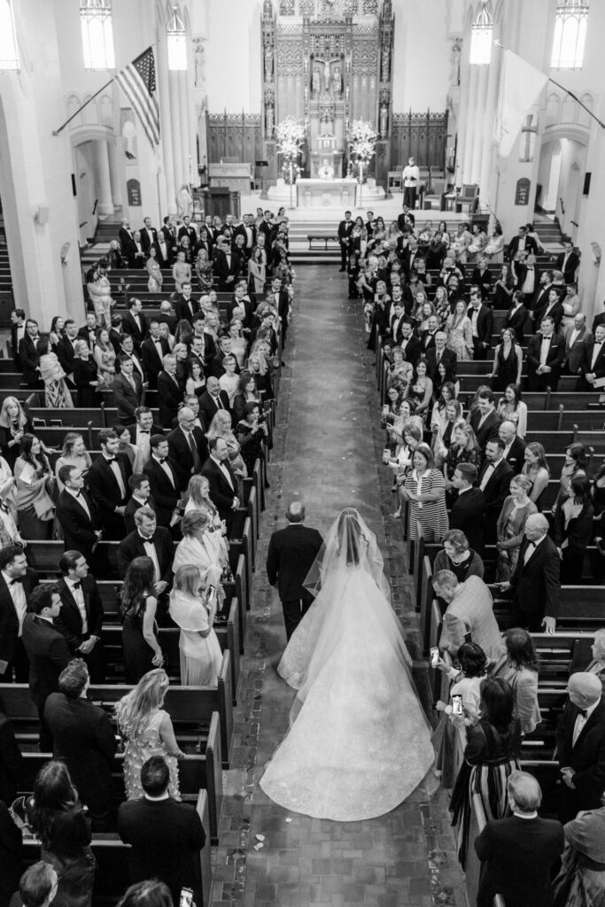Katya Ruiz walks aisle in luxe bridal gown, B&W.