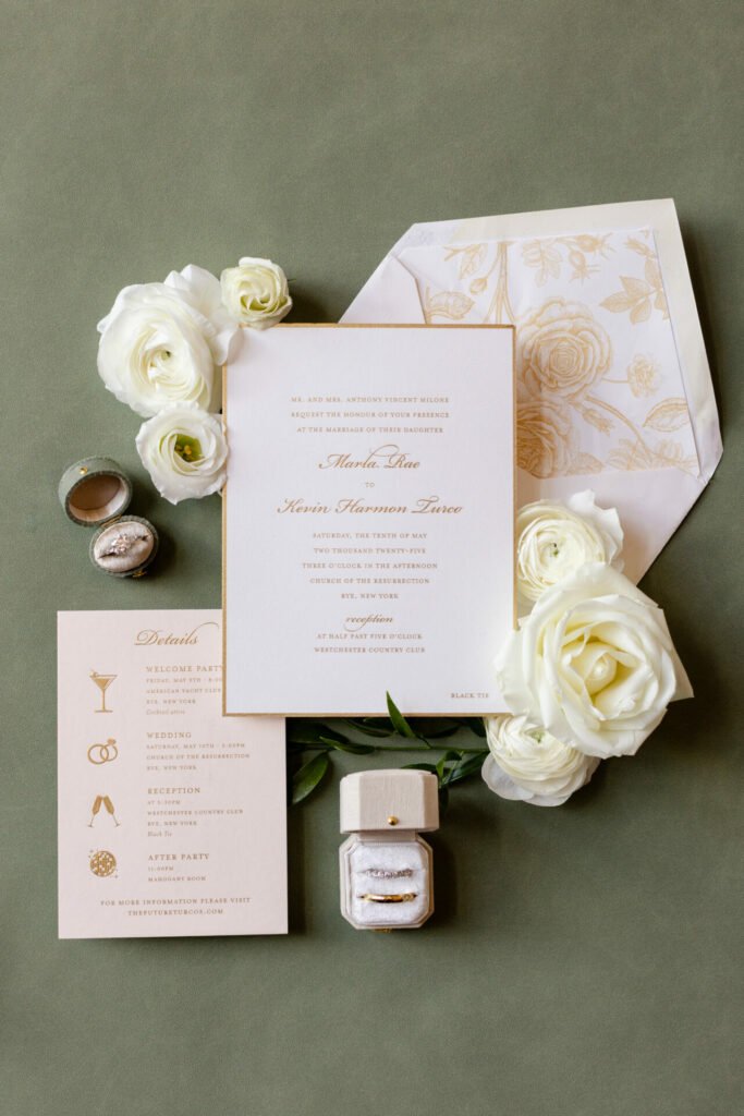 Elegant wedding invitations with roses and rings, flat lay.