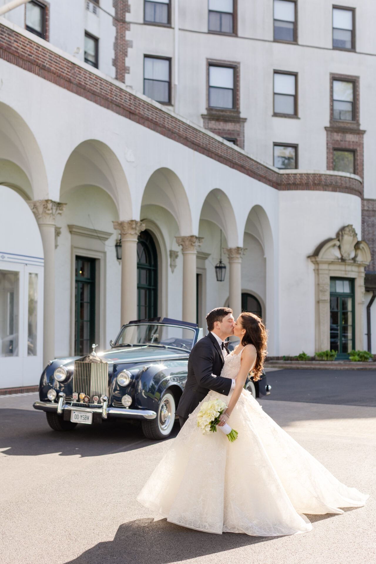 Katya Ruiz kisses groom by blue Rolls-Royce, stunning in couture gown.