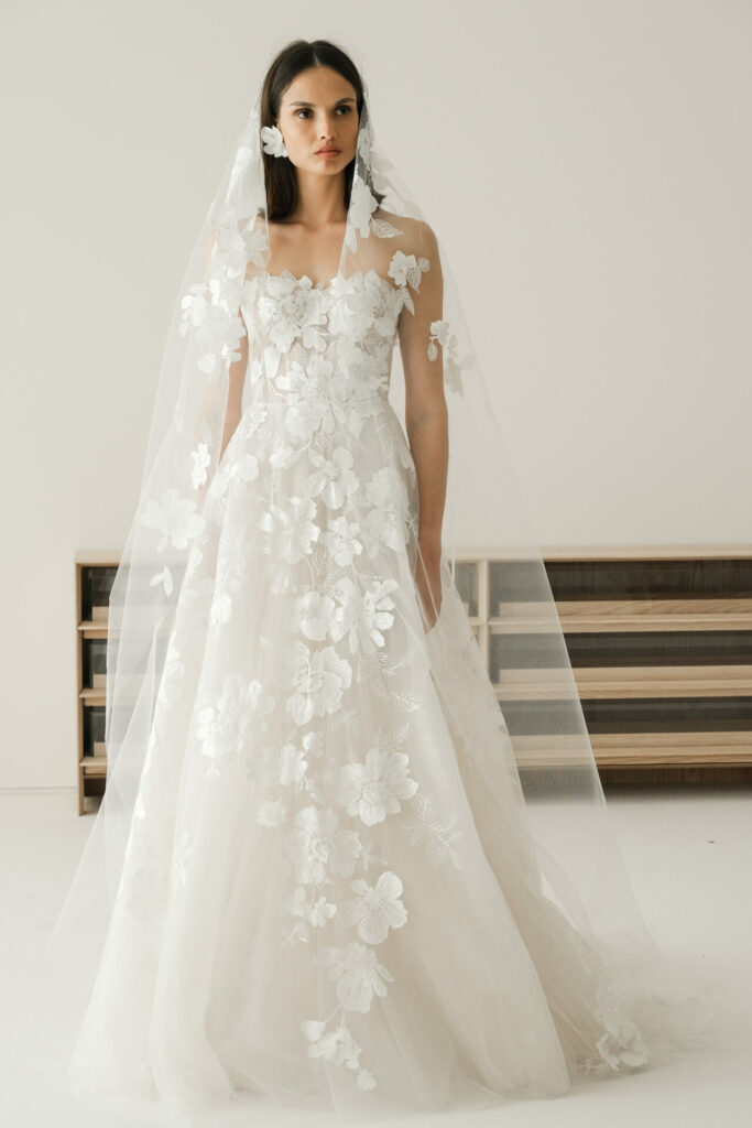 Woman in white floral Ness & Nessia wedding dress.
