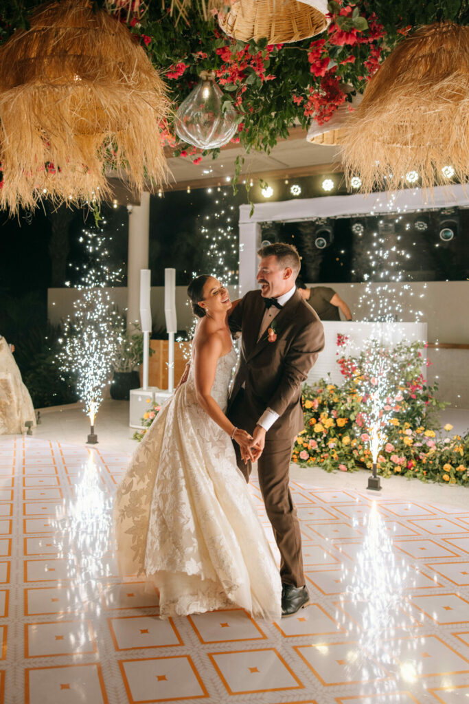 Katya Ruiz dances in couture gown amid fireworks, florals.
