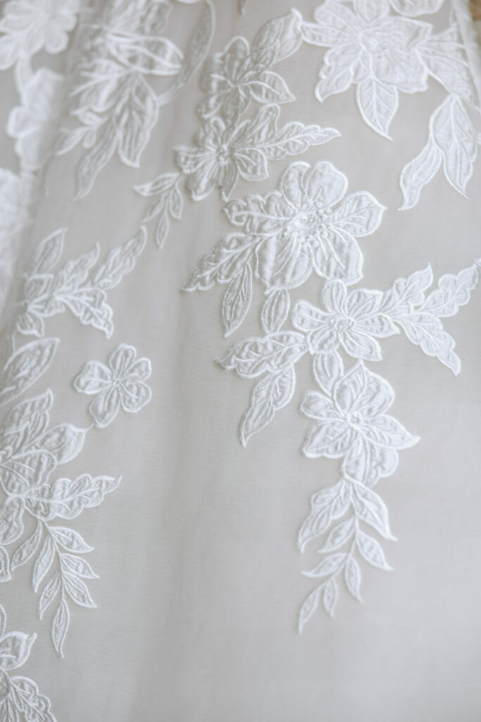White floral lace embroidery with intricate patterns.