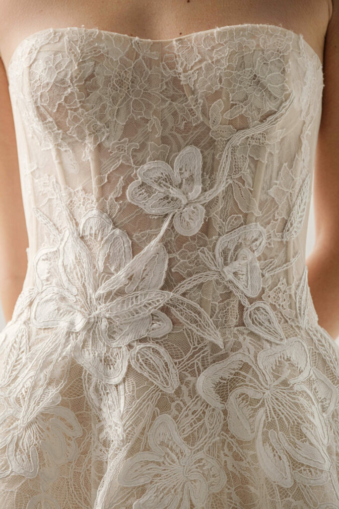 Nera strapless wedding dress with sheer floral lace.