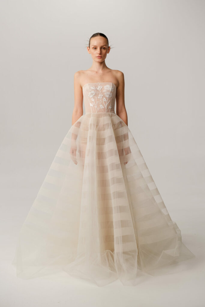 Back view of the Elka strapless wedding dress styled with detachable floral tulle sleeves