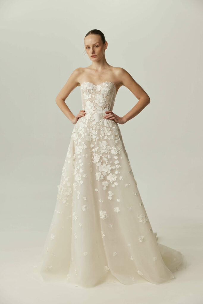 Woman in strapless white gown with 3D florals.