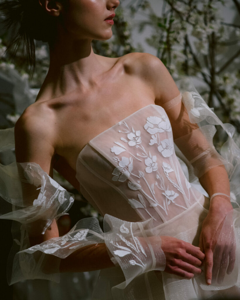 Bride in motion wearing the Elka tulle ball gown strapless wedding dress by Mira Zwillinger