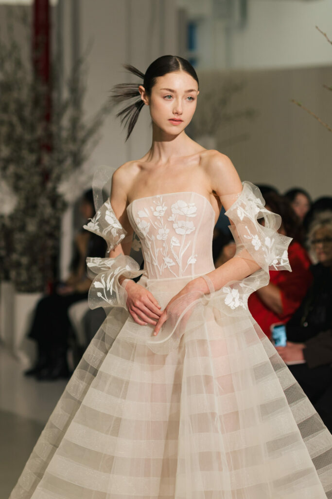 Side view of the Elka strapless wedding dress with structured voluminous tulle ball gown skirt