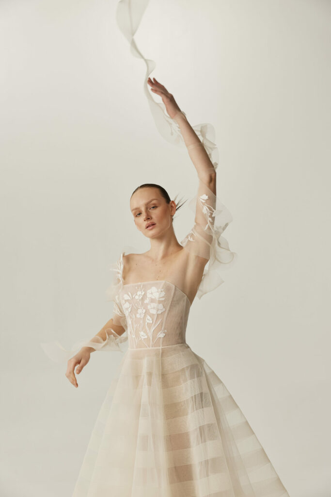 Bride wearing the Elka strapless wedding dress from Mira Zwillinger's SS27 'The Rise' collection