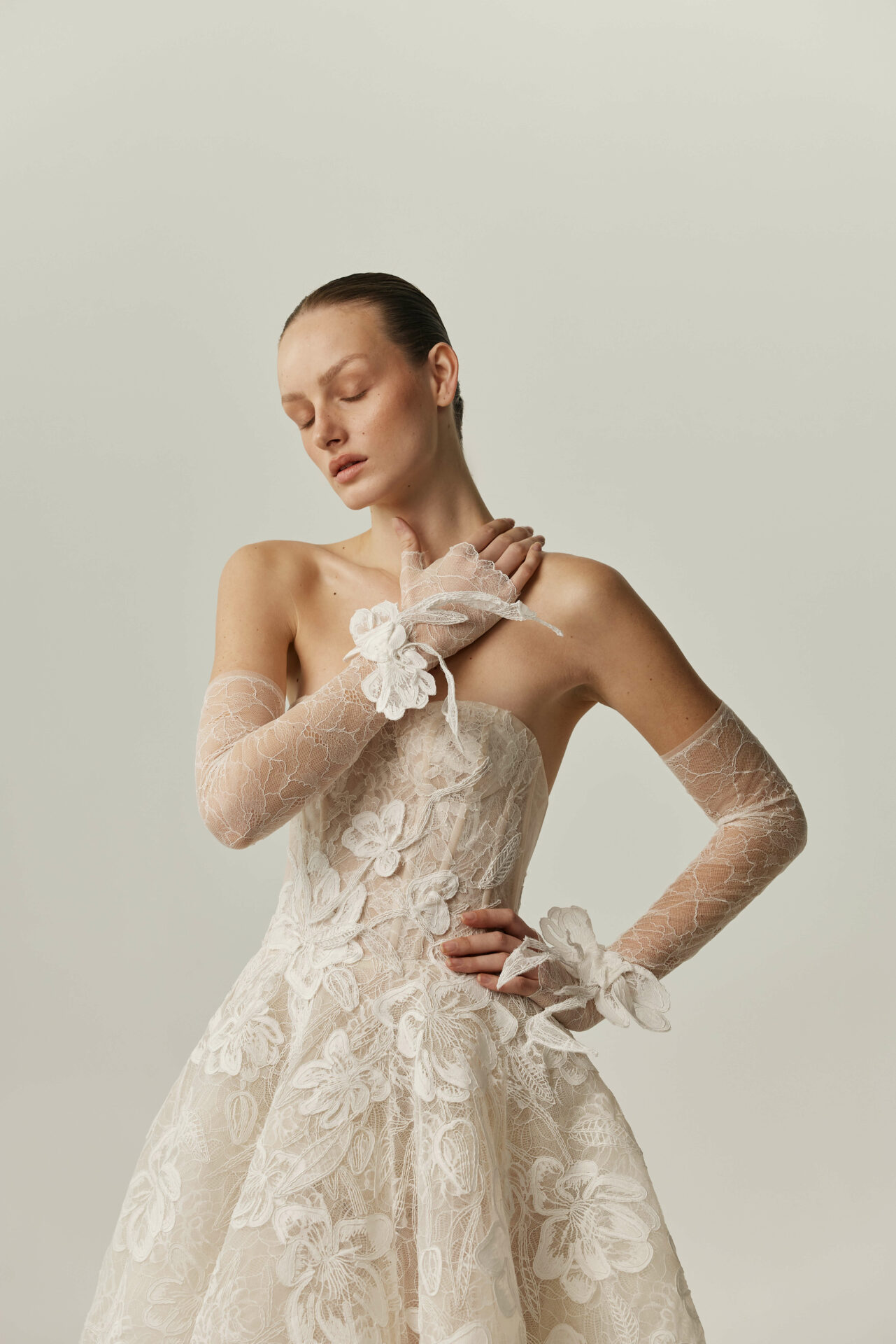 Nera strapless ball gown with floral embroidery and Solstiss lace gloves by Mira Zwillinger