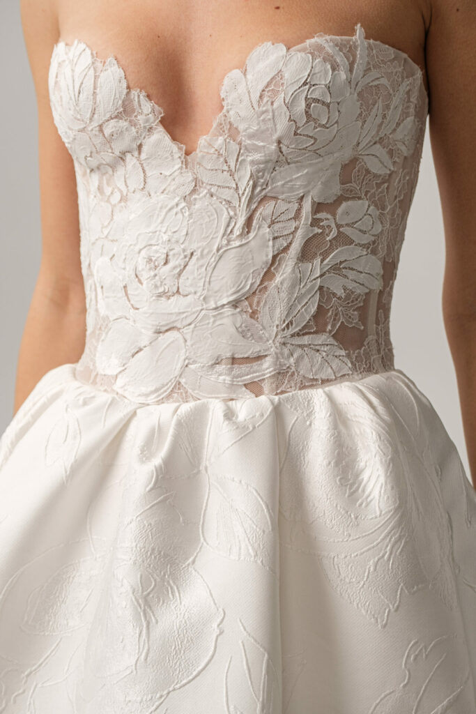 Strapless Clea dress with floral lace, fitted waist.
