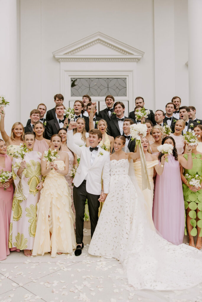 Katya Ruiz and groom celebrate outdoors with wedding party.