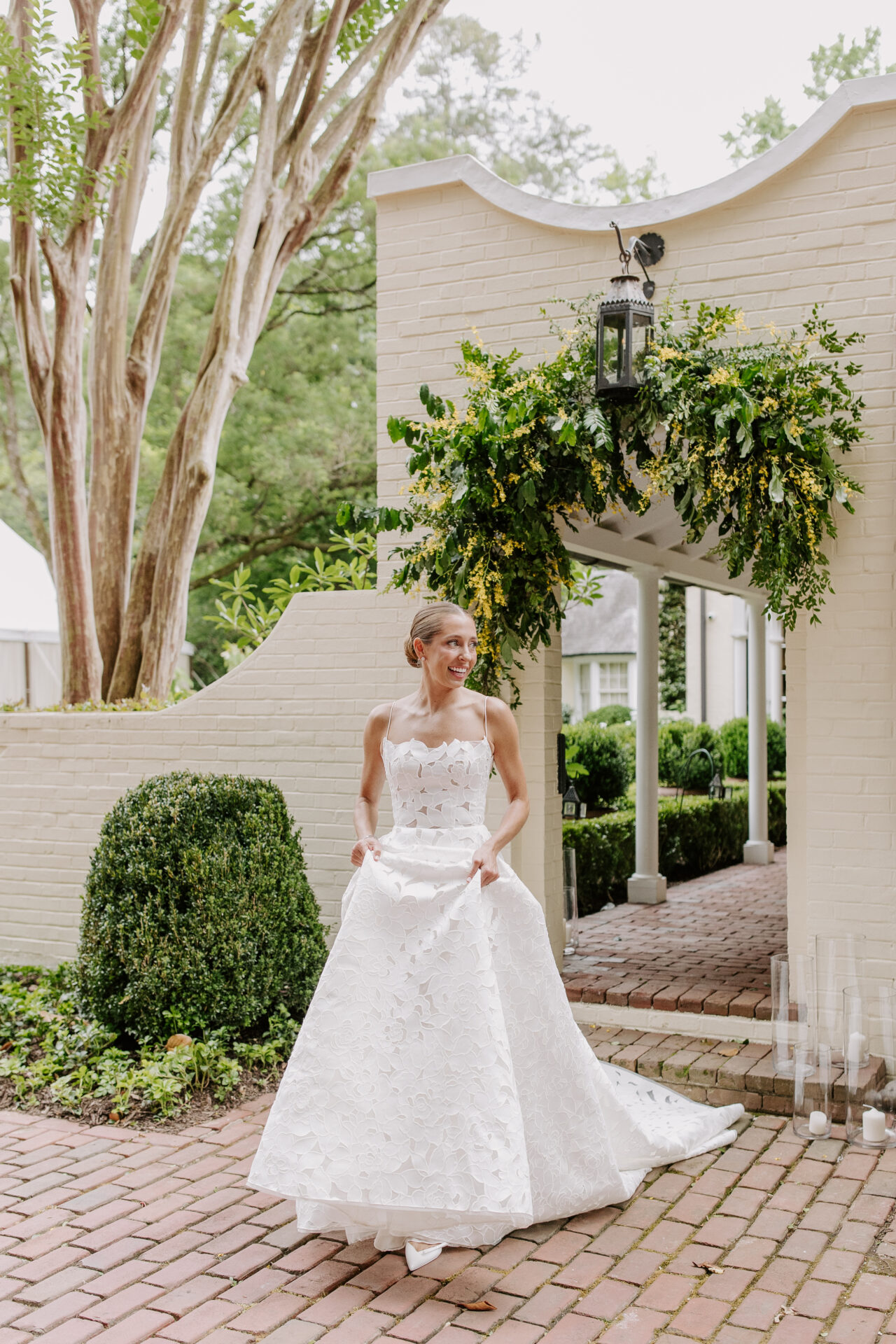 Rebecca wearing the Ayla wedding gown by Mira Zwillinger at her garden wedding