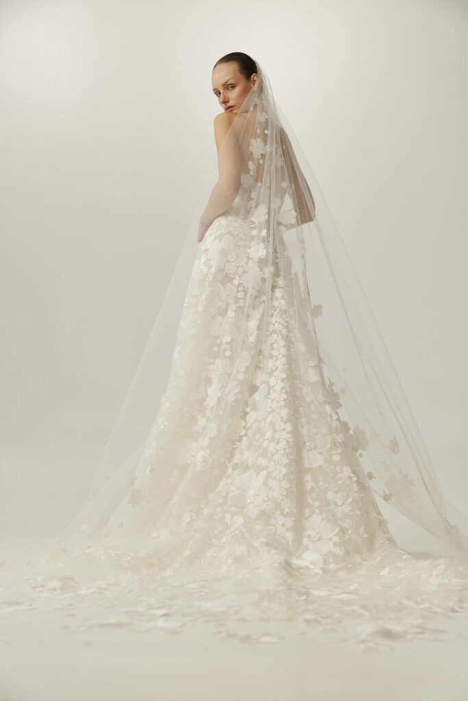 Bride in floral Clea dress and veil, ethereal look.