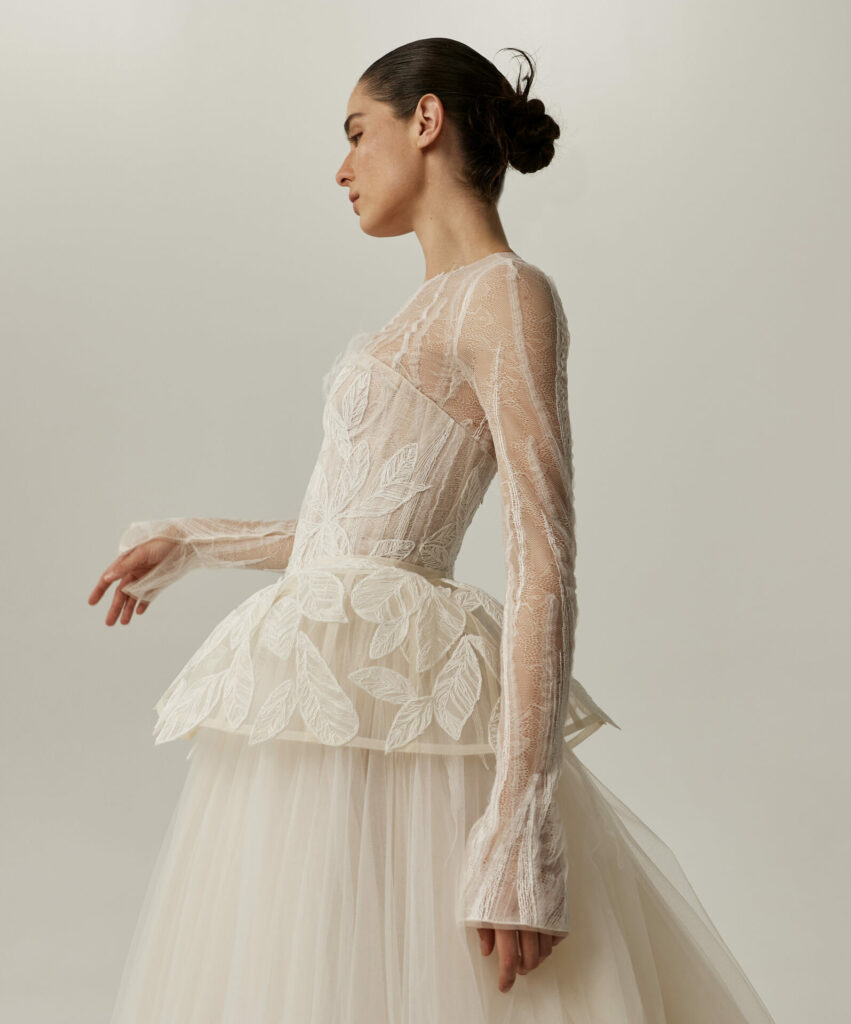 Mira Zwillinger SS2027 bride in sheer leaf-patterned couture wedding dress with low bun.