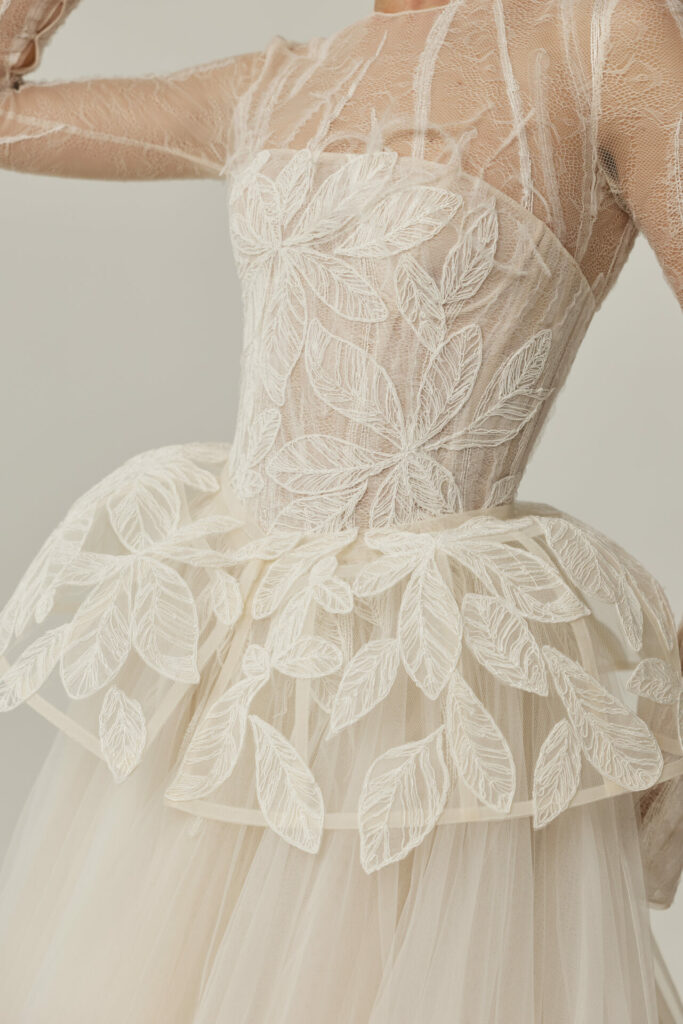 Sheer strapless gown with layered tulle and leaf appliqué.