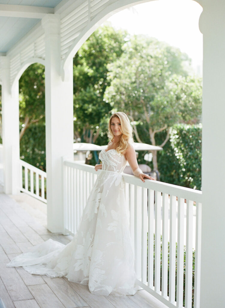 Katya Ruiz in glowing white wedding dress, sunlit veranda.