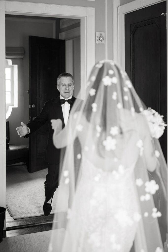 Tuxedoed man welcomes bride in heartfelt moment.