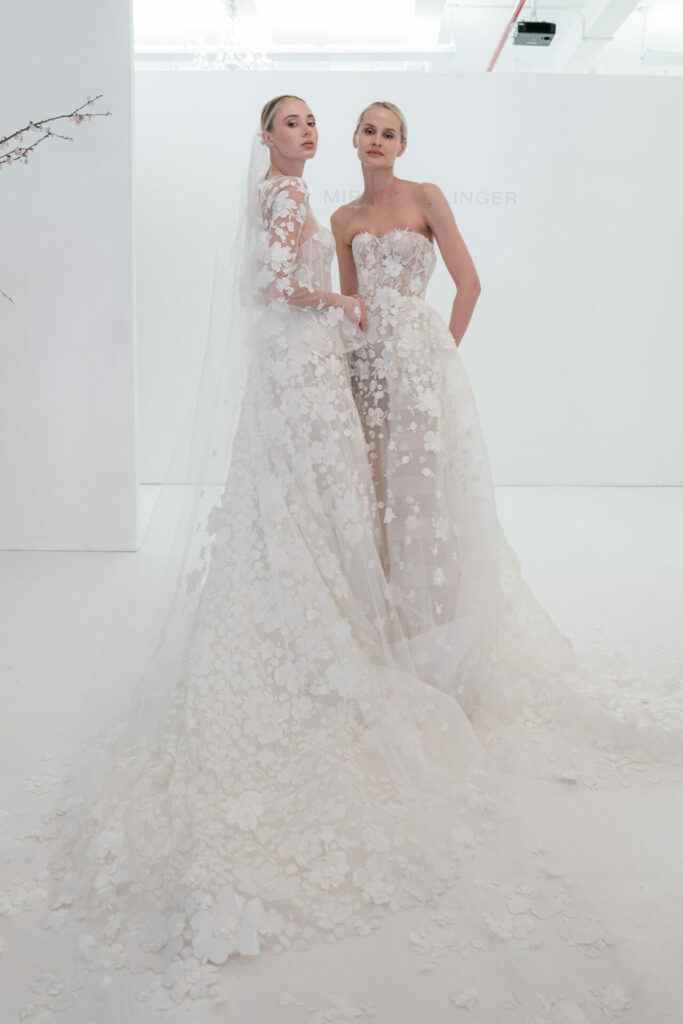 Ness & Nessia pose in matching flowing white gowns.