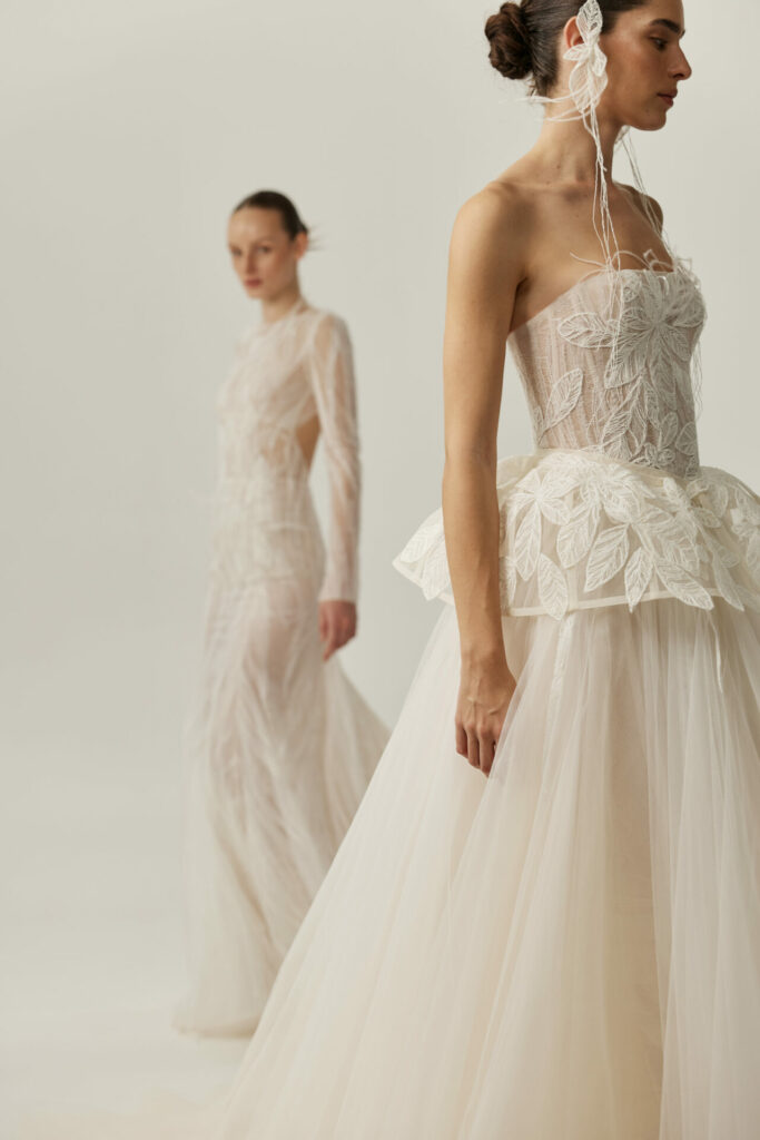 Women in detailed white bridal gowns, one blurred.