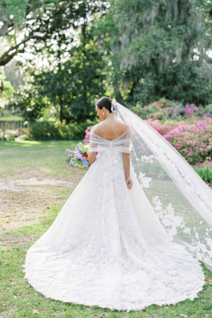 Bride Katya Ruiz outdoors in luxurious white gown.