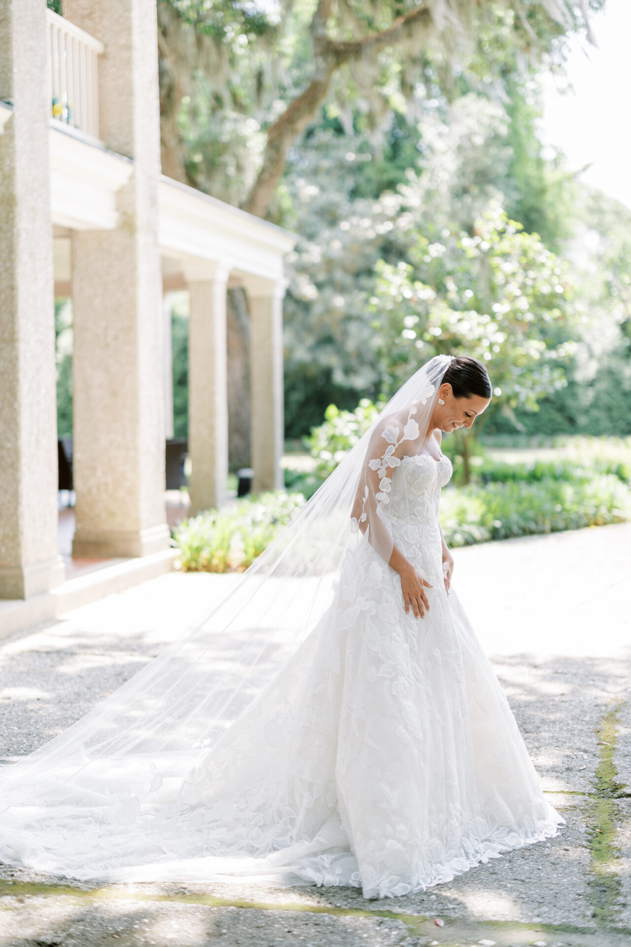 Bride Katya Ruiz in floral lace gown outdoors.